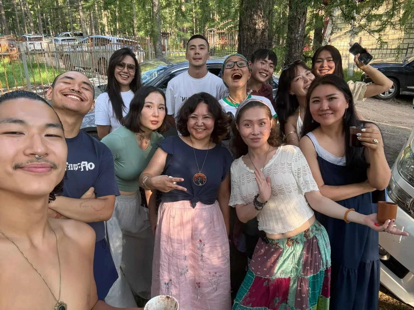 Members of the Greensnake community crowded together for a photograph among pine trees